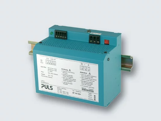 Picture of a PULS standard power supply in 1997 for DIN rail mounting.